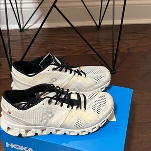 On cloud Cream and Black Athletic Shoes